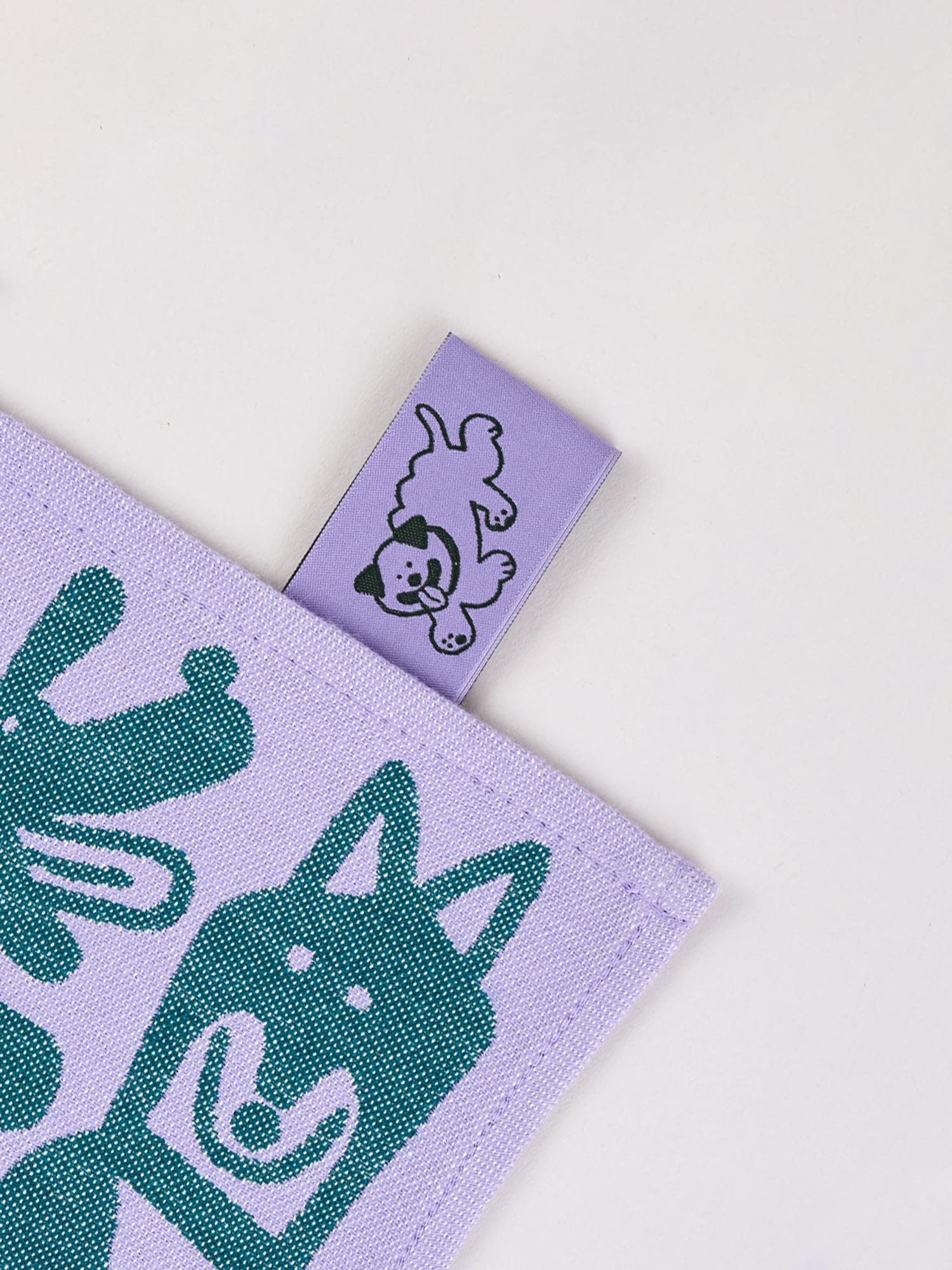 dog graphic tea towel in purple and green