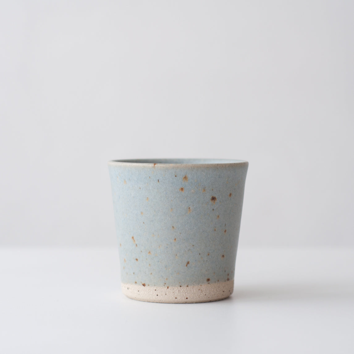 Light blue hand thrown ceramic beaker mug by Dor & Tan